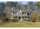 Charming two-story home featuring a welcoming front porch and well-manicured lawn surrounded by mature trees at 928 Gate Post Ln, Lawrenceville, GA 30044