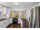 Bright kitchen features stainless steel appliances, white cabinets and dark granite countertops at 928 Gate Post Ln, Lawrenceville, GA 30044
