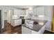 Well-designed kitchen featuring granite countertops, white cabinets, and sleek stainless steel appliances at 928 Gate Post Ln, Lawrenceville, GA 30044