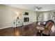 Comfortable living room with hardwood floors, a cozy fireplace, and lots of natural light at 928 Gate Post Ln, Lawrenceville, GA 30044