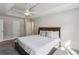 Main bedroom with tray ceiling, ceiling fan, and lots of natural light at 928 Gate Post Ln, Lawrenceville, GA 30044