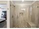 Tile shower features glass door, built in bench, and built in shelving at 928 Gate Post Ln, Lawrenceville, GA 30044