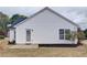Backyard with minimal landscaping, grassy area, and vinyl siding at 732 Jacoby Dr, Loganville, GA 30052