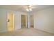 A spacious carpeted bedroom with connecting bathroom, closet, and hallway doors at 732 Jacoby Dr, Loganville, GA 30052