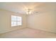 A bright, carpeted bedroom with a ceiling fan and a window at 732 Jacoby Dr, Loganville, GA 30052