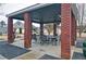Open brick pavilion with picnic tables, seating, and landscaped surroundings at 732 Jacoby Dr, Loganville, GA 30052