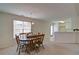 Cozy dining area with a classic wooden table set, ample lighting, and views into the kitchen at 732 Jacoby Dr, Loganville, GA 30052