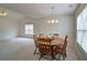 Dining room with large window, overhead lighting, and neutral carpeting at 732 Jacoby Dr, Loganville, GA 30052