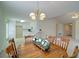Dining room with hardwood table and white walls adjacent to the kitchen space at 732 Jacoby Dr, Loganville, GA 30052
