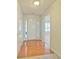 Bright entryway featuring hardwood floors, a white front door with sidelights, and access to other rooms at 732 Jacoby Dr, Loganville, GA 30052