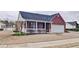 Charming brick home featuring a covered porch, a well-manicured lawn, and attached garage at 732 Jacoby Dr, Loganville, GA 30052