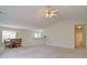 Bright, open living area with plush carpeting, a dining set, and natural light at 732 Jacoby Dr, Loganville, GA 30052