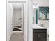Hallway view of a modern bathroom featuring a sleek vanity and stylish decor leading to the stairs at , Duluth, GA 30096