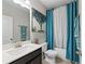 Modern bathroom featuring a sleek vanity, stylish mirror, and blue accents, creating a serene space at , Duluth, GA 30096