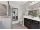 Main bathroom with a walk-in shower and a vanity with black cabinets at , Duluth, GA 30096