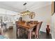 Elegant dining room with modern chandelier, wood table and chairs, and open access to kitchen at , Duluth, GA 30096