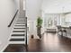 Inviting foyer features hardwood floors, staircase, and a view into the kitchen at , Duluth, GA 30096