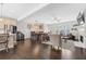 Open-concept living area with dark hardwood floors, fireplace, and ample seating, with access to dining and kitchen at , Duluth, GA 30096
