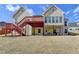 Spacious backyard featuring a deck, covered patio, and a well-maintained lawn, perfect for outdoor gatherings at 3426 Olivia Grace Way, Dacula, GA 30019