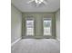 Neutral bedroom featuring carpeted flooring and two windows allowing natural light at 3426 Olivia Grace Way, Dacula, GA 30019