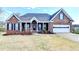 Charming single-story brick home with a manicured lawn and inviting front porch at 3426 Olivia Grace Way, Dacula, GA 30019