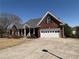 Charming brick home featuring a spacious driveway, attached garage, and well-manicured landscaping at 3426 Olivia Grace Way, Dacula, GA 30019