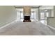 Open living area featuring a fireplace, carpet, and seamless flow to adjacent rooms at 3426 Olivia Grace Way, Dacula, GA 30019