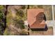 Aerial view of a well-maintained property with a brown roof, a driveway, and a yard with mature trees at 4970 Wewatta Sw St, Atlanta, GA 30331
