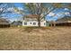 The backyard features a large lawn area, partially obscured by trees, and a wooden fence at 4970 Wewatta Sw St, Atlanta, GA 30331