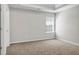 Bedroom featuring carpeting, neutral walls, and large window at 4970 Wewatta Sw St, Atlanta, GA 30331