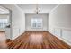 Formal dining room with wainscoting, a chandelier, and rich laminate floors at 4970 Wewatta Sw St, Atlanta, GA 30331