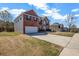 Traditional two-story home with a two-car garage and driveway; a side yard is visible at 4970 Wewatta Sw St, Atlanta, GA 30331