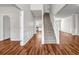Home foyer boasting hardwood floors, paneled walls, and a staircase at 4970 Wewatta Sw St, Atlanta, GA 30331