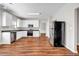 Well-lit kitchen featuring laminate flooring, white cabinetry, and modern appliances at 4970 Wewatta Sw St, Atlanta, GA 30331