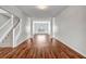 An open-concept living room featuring hardwood floors and decorative columns at 4970 Wewatta Sw St, Atlanta, GA 30331