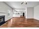 Open concept living room with fireplace and hardwood floors and connecting view of the kitchen at 4970 Wewatta Sw St, Atlanta, GA 30331
