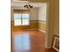 Bright dining room with beautiful hardwood floors, a chandelier, and large window at 7925 Timberline Overlook, Cumming, GA 30041
