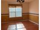 Cozy dining room with hardwood floors, lovely window with a valance, and wallpaper trim at 7925 Timberline Overlook, Cumming, GA 30041