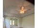 Bright and spacious main bedroom with a tray ceiling, ceiling fan, and door to outside at 7925 Timberline Overlook, Cumming, GA 30041