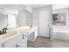 Bright bathroom featuring a large mirror, double sinks, and a tub at 1484 Highland Bluff Ct, Suwanee, GA 30024