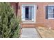 Inviting entryway with classic brick, white trim, and a well-maintained landscape at 1484 Highland Bluff Ct, Suwanee, GA 30024