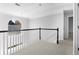 Upstairs hallway with natural light and railing at 1484 Highland Bluff Ct, Suwanee, GA 30024