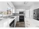 Modern kitchen featuring white cabinets, quartz countertops, tile backsplash and stainless steel appliances at 1484 Highland Bluff Ct, Suwanee, GA 30024