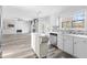 Bright, open kitchen with an island, stainless steel appliances, and views of living room fireplace at 1484 Highland Bluff Ct, Suwanee, GA 30024