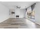 Spacious living room boasts a fireplace, ceiling fan and a large window at 1484 Highland Bluff Ct, Suwanee, GA 30024
