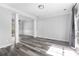 Open concept living room with wood floors, crown molding, and natural light at 1484 Highland Bluff Ct, Suwanee, GA 30024