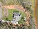 A top-down aerial of a brick home with a firepit, a yard, and mature trees at 180 Allie Dr, Mcdonough, GA 30252