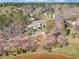 An aerial view shows the home with the outdoor fire pit and its proximity to the lake at 180 Allie Dr, Mcdonough, GA 30252