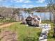 Aerial view of a brick home with mature trees and a lake in the background at 180 Allie Dr, Mcdonough, GA 30252
