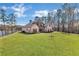 Brick two-story home with manicured lawn and mature trees on a sunny day at 180 Allie Dr, Mcdonough, GA 30252